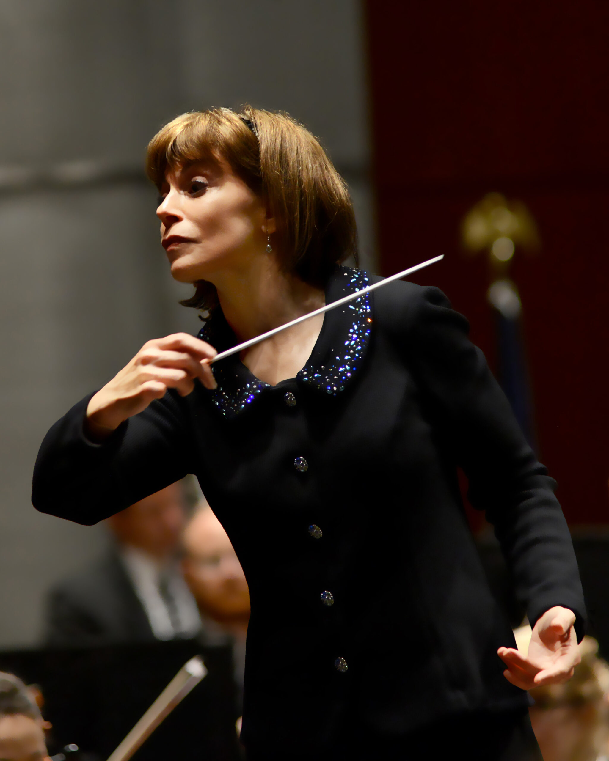 JoAnn Felletta wearing black and conducting
